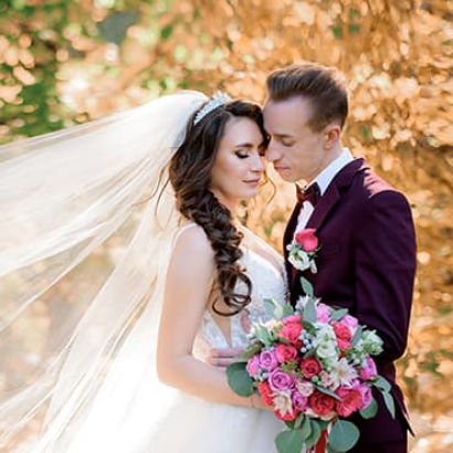 Bride and groom embracing in a garden